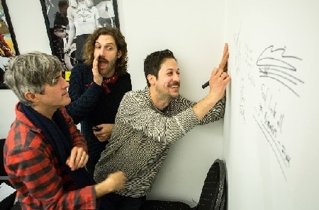 Happy BIMM University Berlin students drawing on a whiteboard