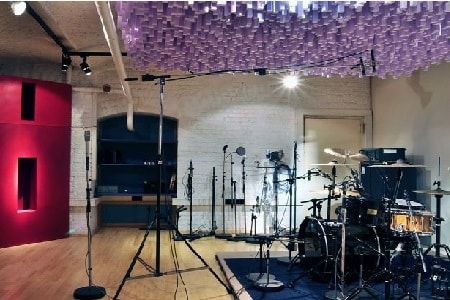 Inside of music production studio with drums and mic stands