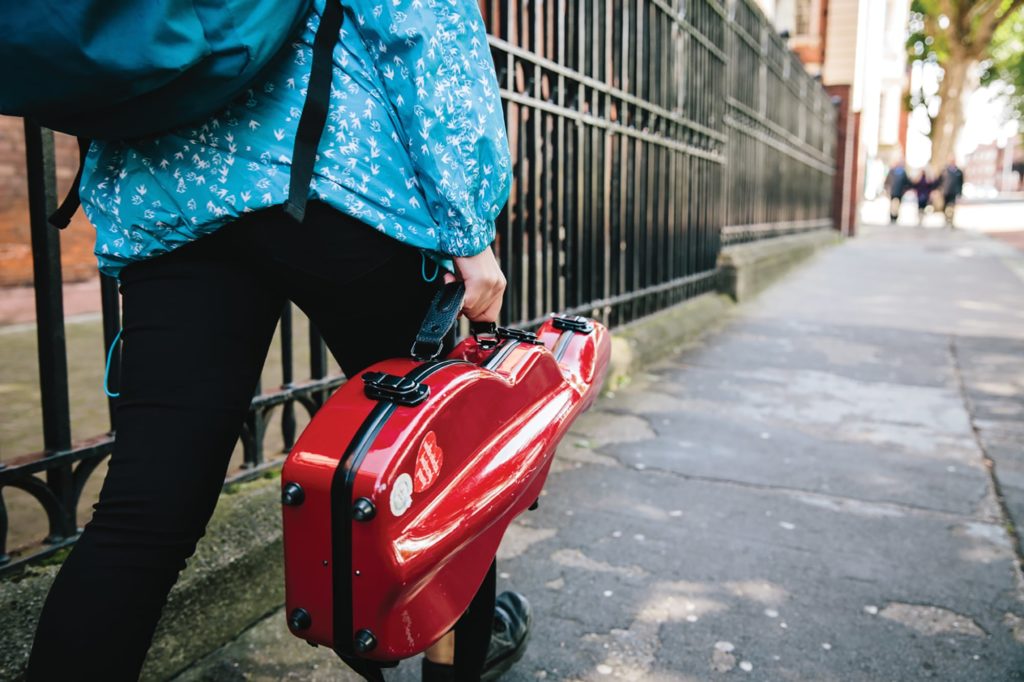 Dublin, a person with a instrument case walks down a road