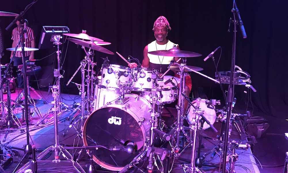 Michael Bowes on stage using drums