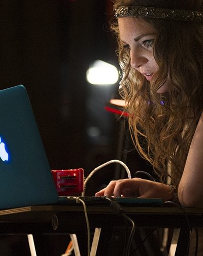 BIMM student using a laptop backstage