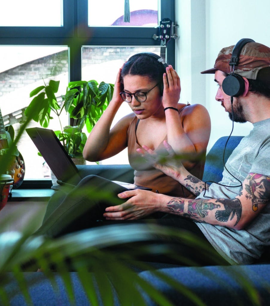 Students sit down together using a laptop