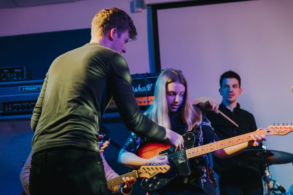 BIMM academy tutor with two students