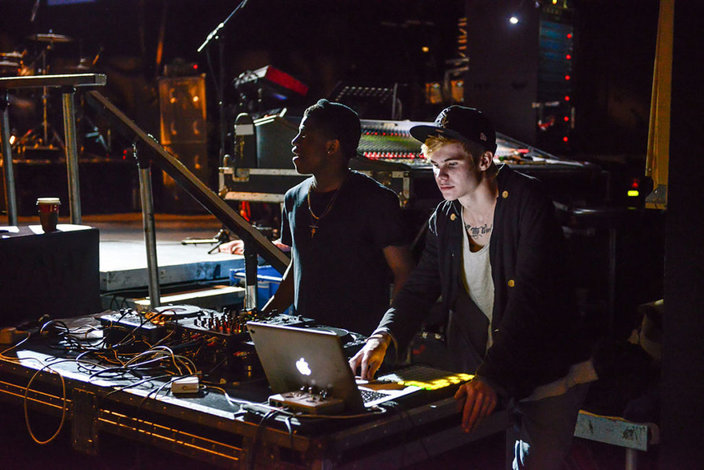 Two students using electronic music equipment