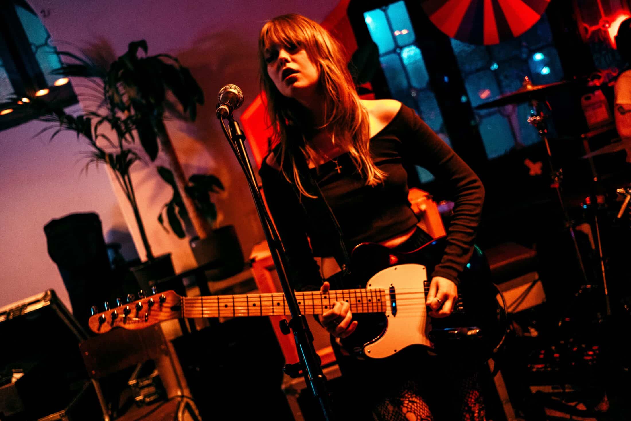 Student playing guitar in dark light on stage at The Great Escape festival